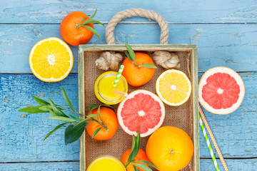 Different fruits and glass with fresh orange juice