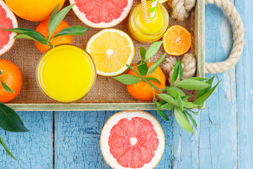 Different fruits and glass with fresh orange juice