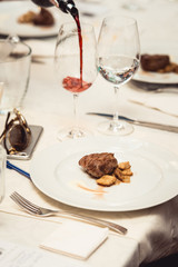 Grilled sliced beef steak on a white plate.