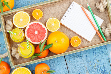 Different fruits and glass with fresh orange juice