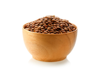 Brown Lentils in wood bowl isolated on white background