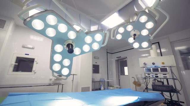 Operational lamps in a hospital room are getting turned on, then off and on again