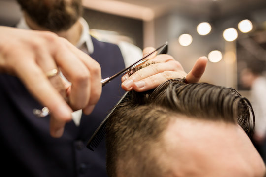 Barber cutting customer hair
