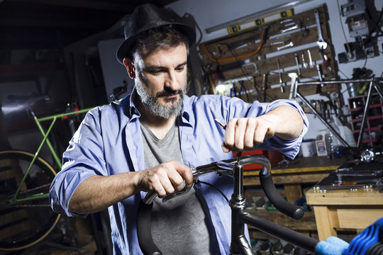 Man working on bicycle in workshop