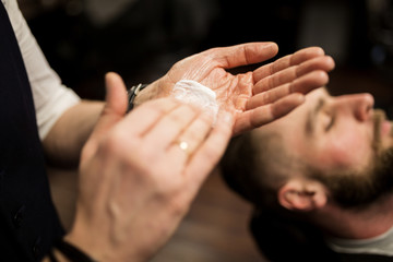 Obraz na płótnie Canvas Barber hands rubbing shaving foam