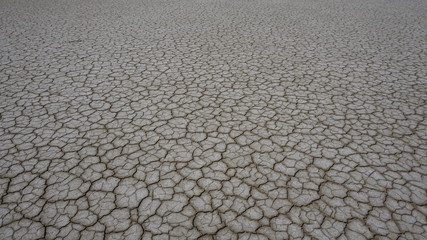 Close up dry land / dry soil. Cracked ground background. Global warming effect. Cracked dry land without water. Abstract background.