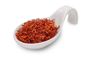 Fototapeta premium saffron in white ceramic spoon on a white background