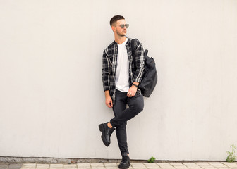 fashion guy posing in sunglasses on sunset