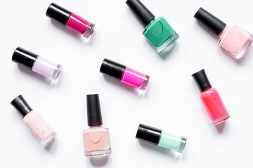 Obraz premium set for nail polish on white table background top view pattern