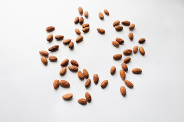 Pile of almonds on white background, healthy eating concept