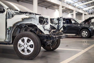 car in automobile repair service center with soft-focus and over light in the background