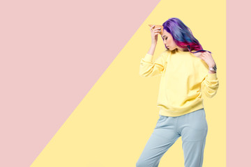 Fototapeta premium attractive young woman pretending unicorn with waffle cone on forehead on creative background