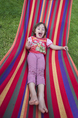 littlegirl having fun in a colourful hammock