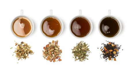 variety of tea blends with relative cups on white background