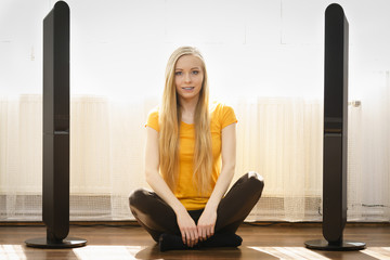 Woman next to speakers at home