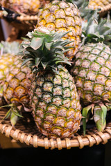 Group of pineapple on the basket in the gourmet market waiting for sell to customer.