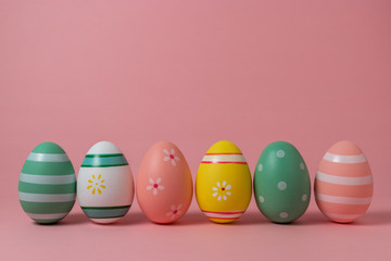 Fototapeta na wymiar Colorful easter eggs on pink background. Easter concept.
