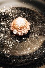 Delicious sweet cupcakes on black plate, delicious homemade dessert