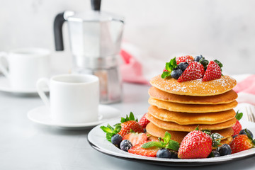 Stack of homemade pancakes for breakfast with berries