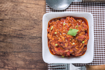 Top View of (Nam prik ong) Northern Thai Meat and Tomato Spicy Dip in a White Cup.