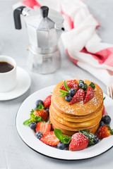 Stack of homemade pancakes for breakfast with berries