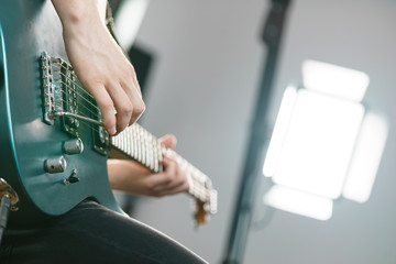 Close up of man playing on electric guitar