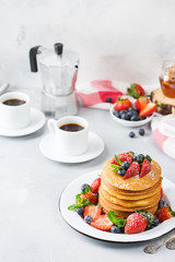 Stack of homemade pancakes for breakfast with berries