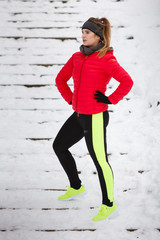 Woman wearing sportswear exercising during winter