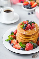 Stack of homemade pancakes for breakfast with berries