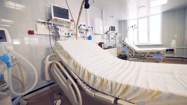 Modern hospital bed in a fully-equipped hospital ward