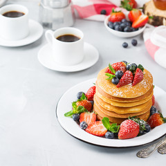 Stack of homemade pancakes for breakfast with berries