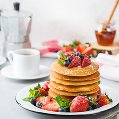 Stack of homemade pancakes for breakfast with berries
