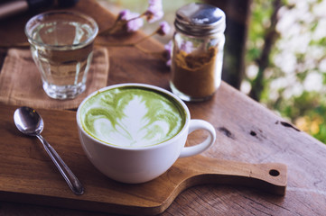 green tea hot drink latte white cup on wood table aroma relax time in coffee shop