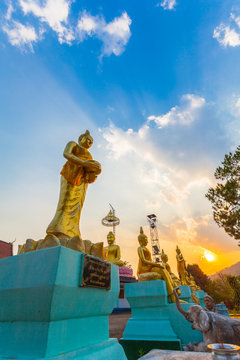 scenery sunset behind the golden buddha statue at wat Sirattanan Mongkol near Mae Kajan Hot Spring. Wiang Pa Pao Chiang Rai Thailand.