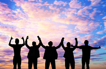 They are standing and show hand together.They are enjoying and also they are watching the evening glow together. They are happy in good time.Photo concept for Silhouetted and team work.