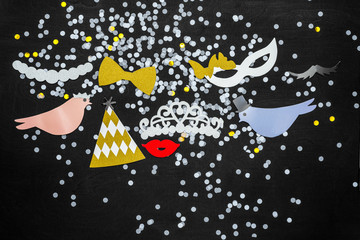 Colorful wedding decoration on black wooden background from above