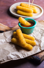 Mozzarella sticks coated with hot sauce.