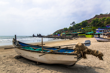 Fototapeta na wymiar fishing boat on tropical sandy beach in sunny day