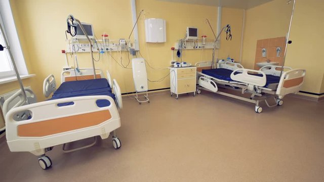 Hospital ward interior with two beds in it.