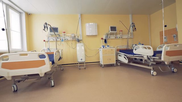 Fully-equipped hospital ward with two wheeled beds and medical inventory
