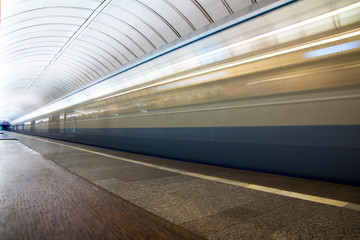 Subway train in motion arriving at station