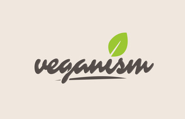Fototapeta premium veganism word or text with green leaf. Handwritten lettering