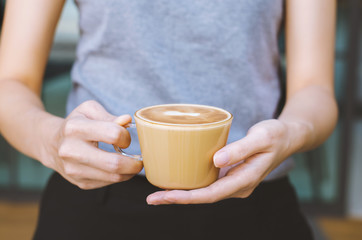beautiful girl hold hot coffee cup serving for your freshness.