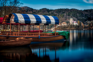 Fototapeta na wymiar Traditional pletna boats on the coast of the Lake Bled in Slovenia