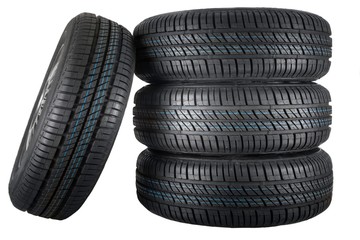 New and unused car tires against isolated background