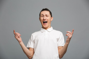 Happy emotional young man pointing.