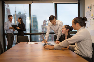 Photo of young businessman crew working untill evening down light with new startup project.Analysis Business Brainstorming Corporate Smart Concept.