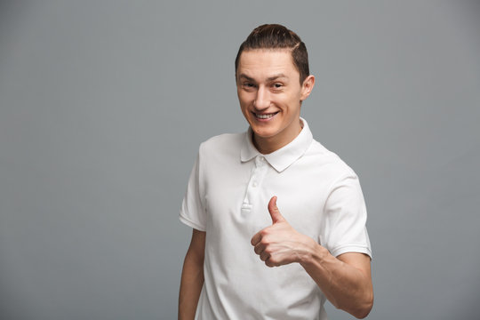 Handsome young man make thumbs up gesture