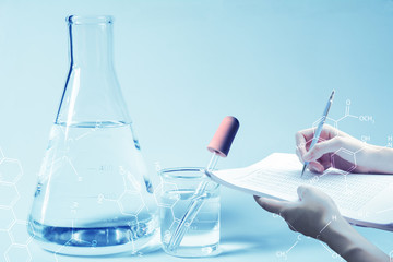 Researcher with glass laboratory chemical test tubes with liquid for analytical , medical, pharmaceutical and scientific research concept.