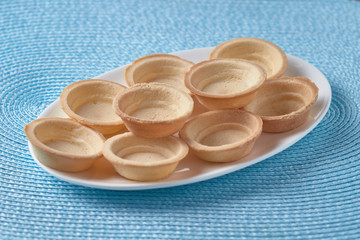 Freshly baked tartlets on a plate.